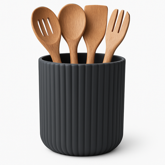 Set of wooden utensils in a black ribbed container on a white background